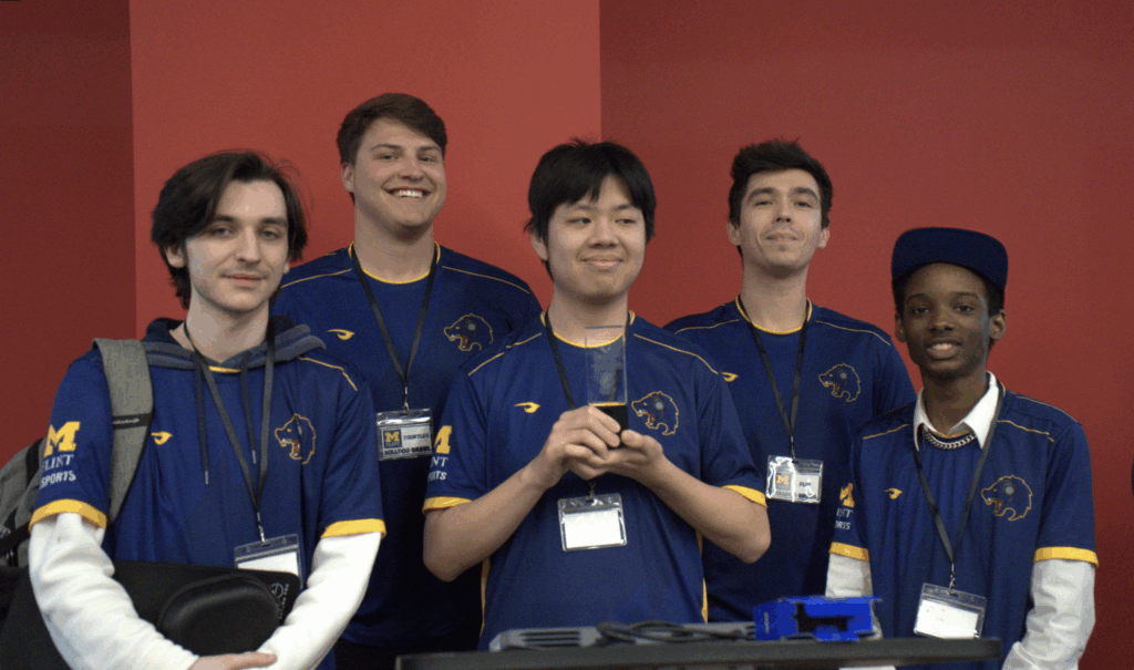 The Valorant Blue team poses with a trophy from the Ferris State LAN event. 